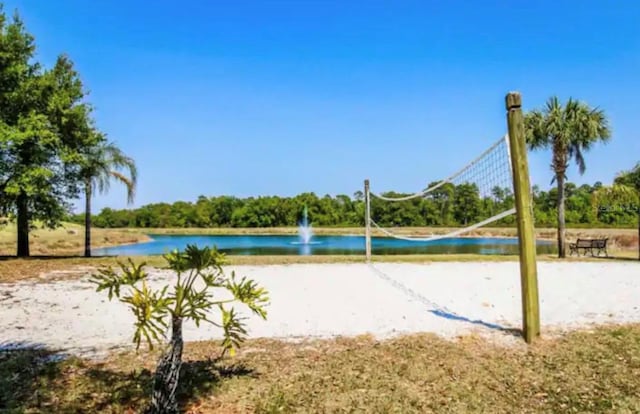 view of home's community featuring volleyball court and a water view