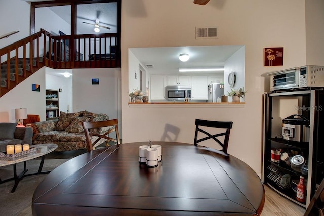 dining space featuring light hardwood / wood-style flooring and ceiling fan