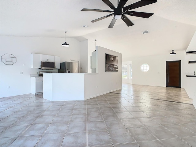 unfurnished living room featuring lofted ceiling, ceiling fan, and light tile patterned floors