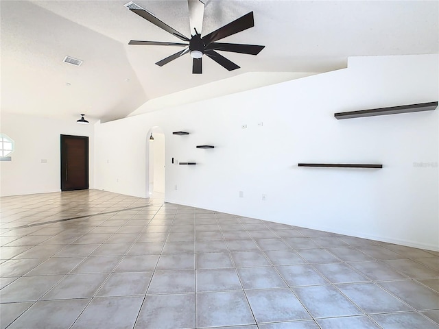 tiled spare room with vaulted ceiling and ceiling fan