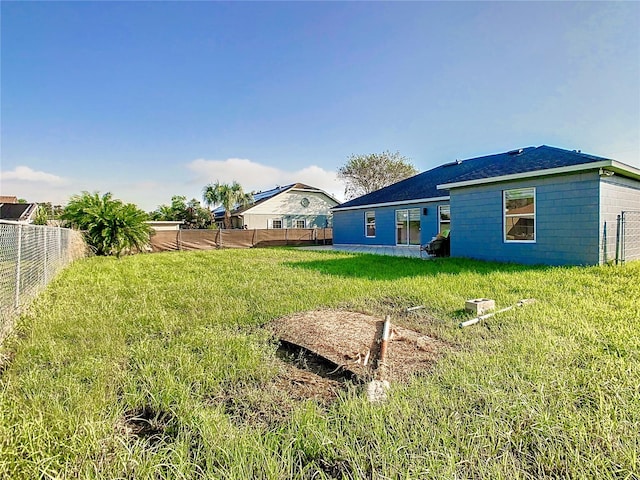 rear view of house with a yard