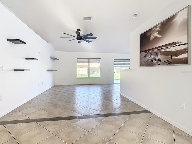 tiled spare room featuring ceiling fan