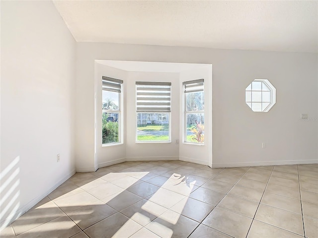 unfurnished room with light tile patterned flooring