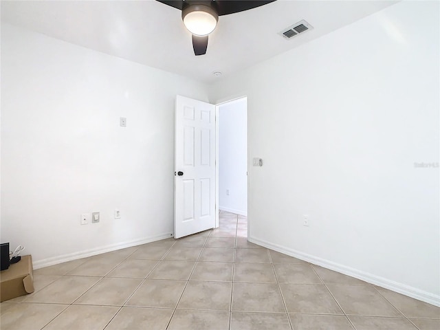 empty room with light tile patterned floors and ceiling fan