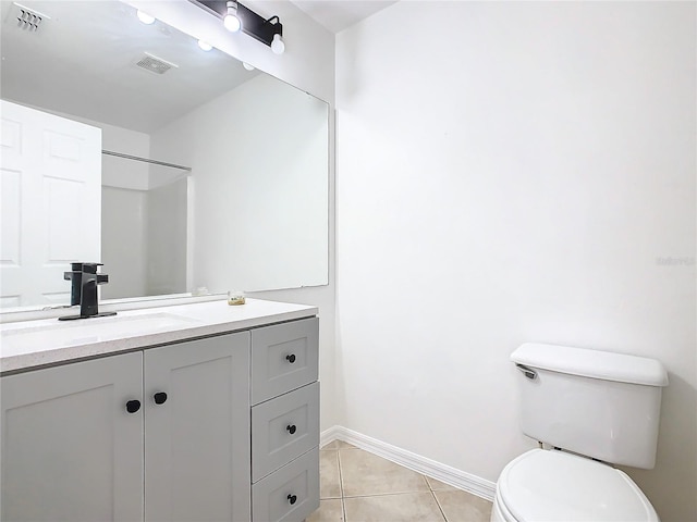 bathroom featuring vanity, a shower, toilet, and tile patterned floors