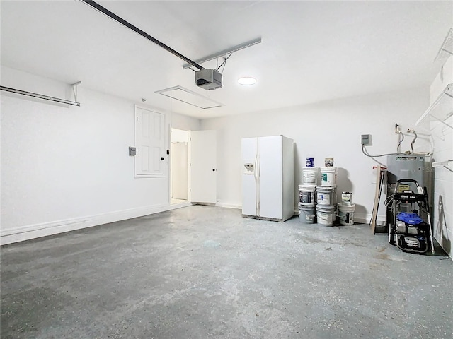 garage with a garage door opener and white refrigerator with ice dispenser