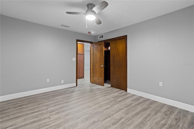 empty room featuring ceiling fan and light hardwood / wood-style flooring