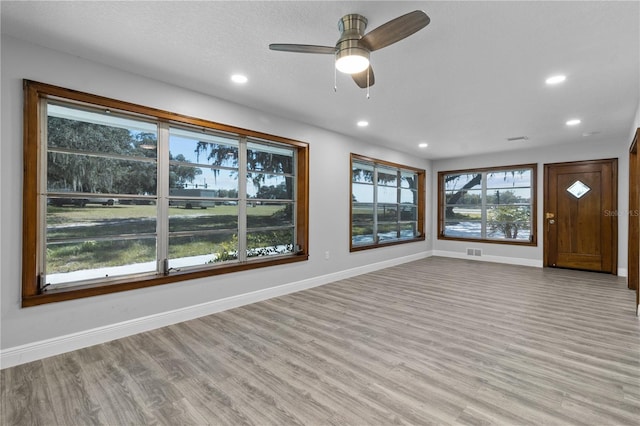 interior space with light hardwood / wood-style floors and ceiling fan