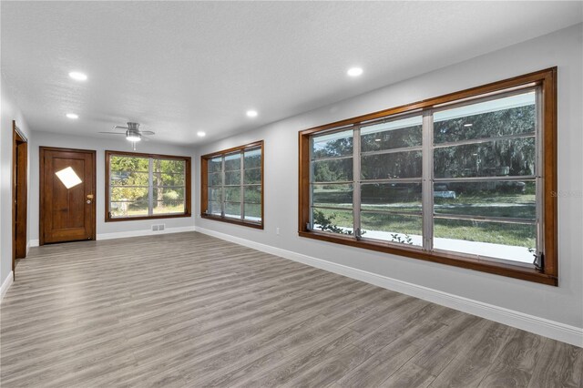 unfurnished room featuring light hardwood / wood-style floors and ceiling fan