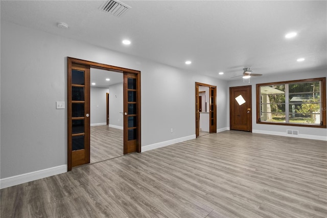 spare room with ceiling fan and light wood-type flooring