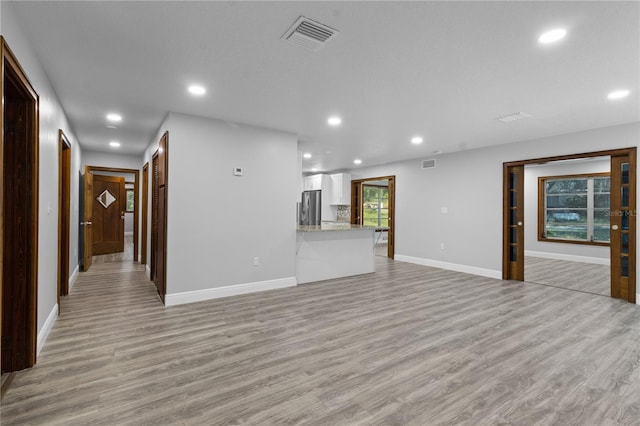 unfurnished living room with light wood-type flooring