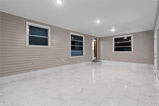 tiled spare room with wood walls