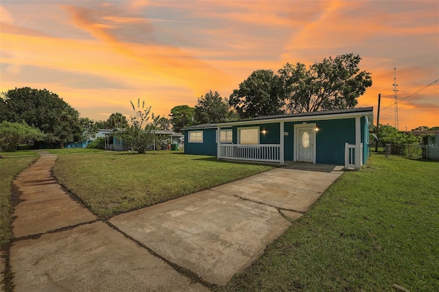 single story home featuring a lawn and a porch