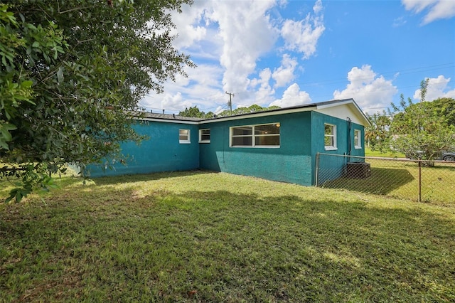 back of house featuring a yard