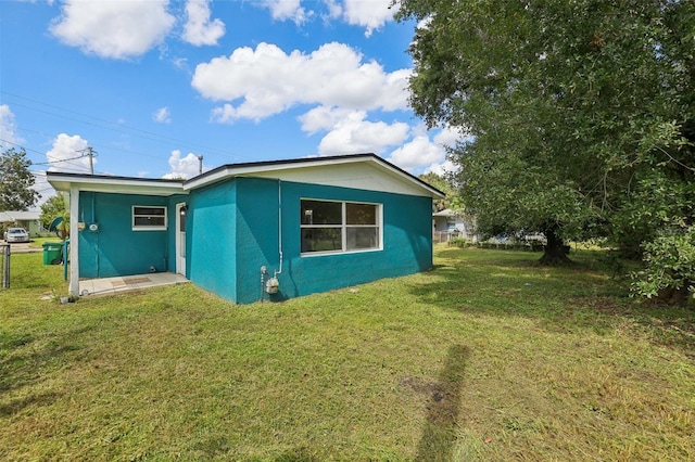 rear view of house featuring a lawn