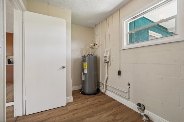 utility room featuring water heater