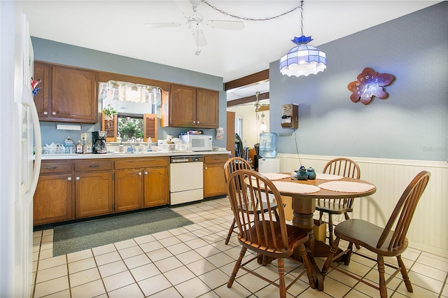 kitchen featuring white appliances, hanging light fixtures, ceiling fan, and light tile flooring