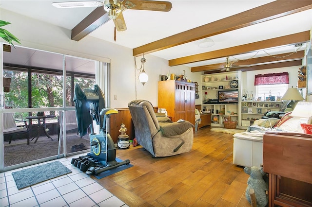 living room with light hardwood / wood-style flooring, ceiling fan, and beamed ceiling