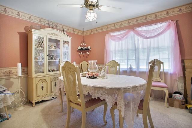 carpeted dining room featuring ceiling fan