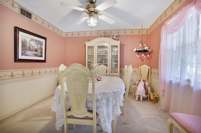 dining area featuring light colored carpet and ceiling fan