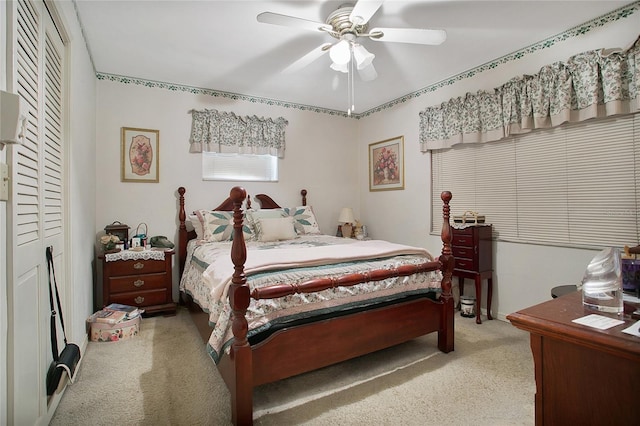 bedroom featuring a closet, light carpet, and ceiling fan