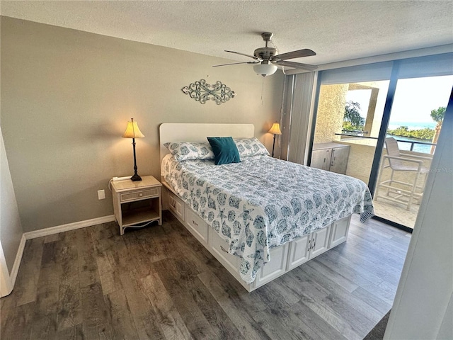 bedroom with a textured ceiling, access to exterior, ceiling fan, and dark wood-type flooring