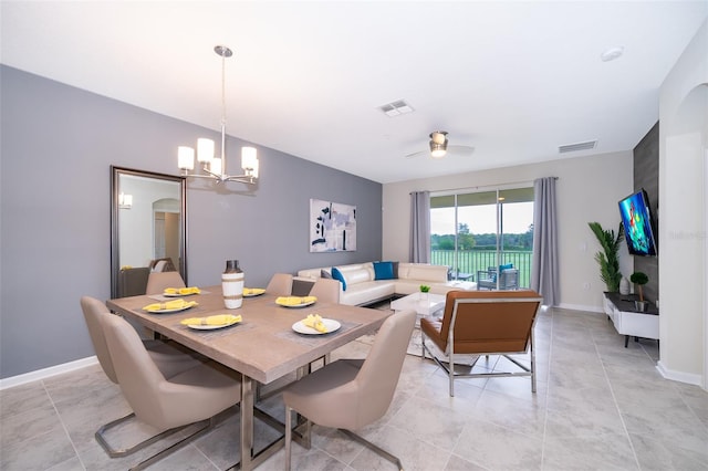 dining room with ceiling fan with notable chandelier and light tile flooring