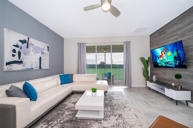 tiled living room featuring ceiling fan