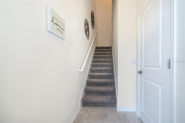 staircase featuring light tile flooring