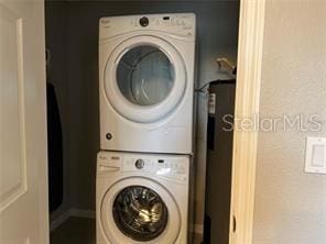 laundry room featuring stacked washer and clothes dryer