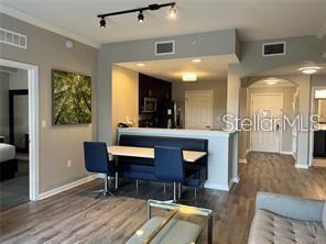 interior space with hardwood / wood-style flooring and ornamental molding