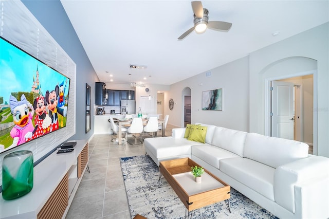 tiled living room with ceiling fan