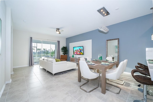 dining area featuring light tile floors and ceiling fan