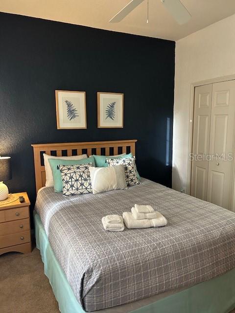 bedroom featuring carpet flooring, a closet, and ceiling fan