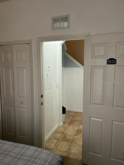 corridor with light tile patterned floors