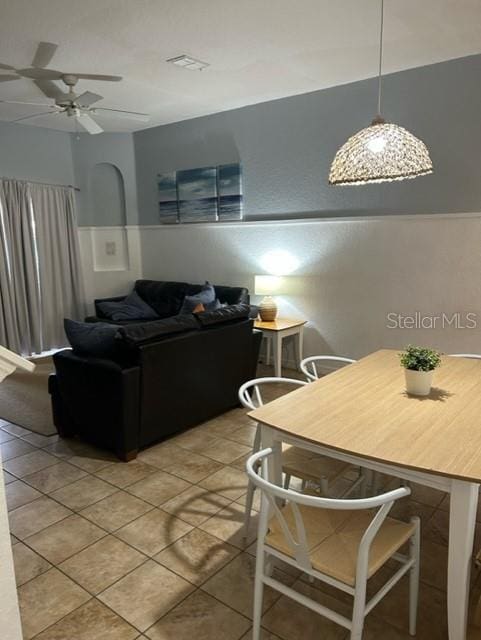 dining room with tile patterned floors and ceiling fan