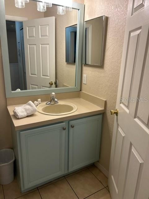 bathroom with tile patterned flooring and vanity