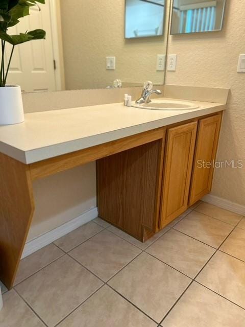 bathroom with tile patterned flooring and vanity