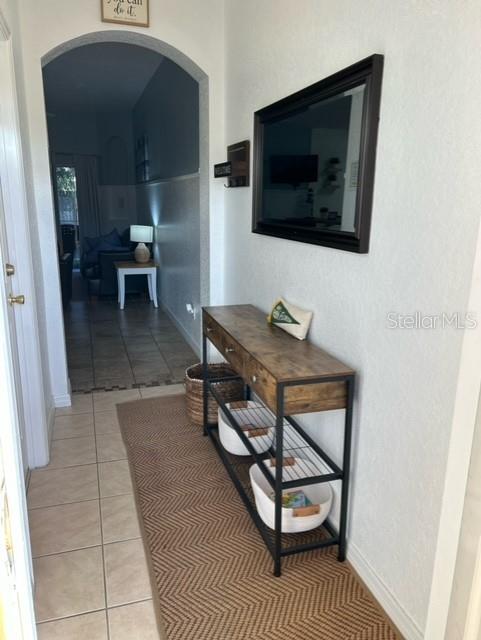 hallway featuring light tile patterned flooring