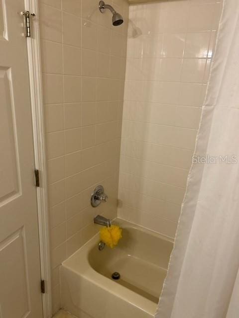 bathroom with shower / bathtub combination with curtain