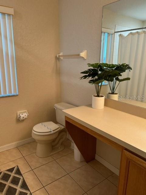 bathroom with tile patterned floors, vanity, toilet, and a shower with shower curtain