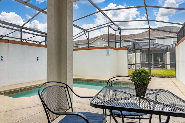 view of swimming pool featuring a patio and a lanai