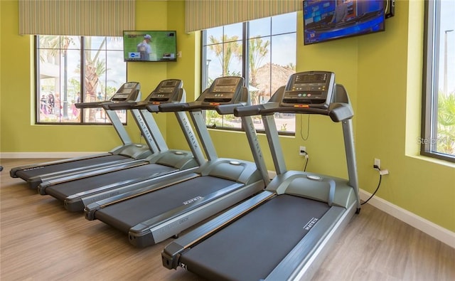 gym with plenty of natural light and light hardwood / wood-style floors