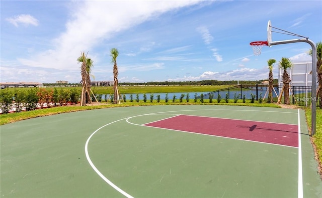 view of basketball court with a water view