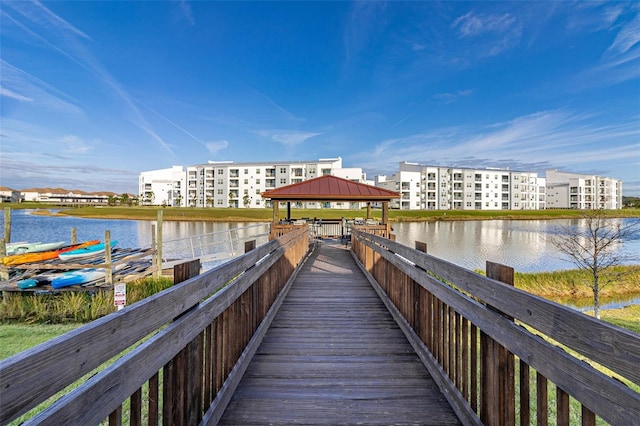 view of dock with a gazebo and a water view