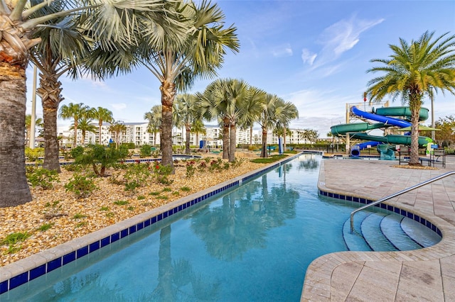 view of swimming pool with a water slide