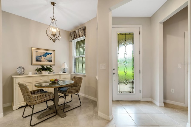 interior space featuring a chandelier, a healthy amount of sunlight, and light tile floors