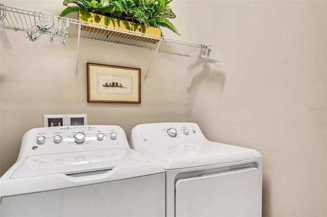 washroom with washer hookup and independent washer and dryer