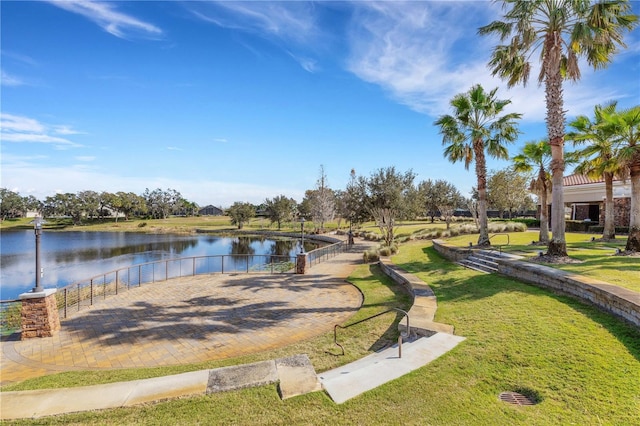 exterior space featuring a lawn and a water view