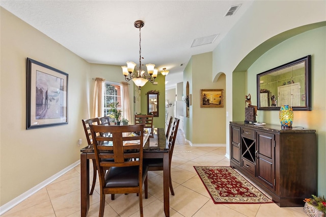 dining room featuring an inviting chandelier and light tile floors